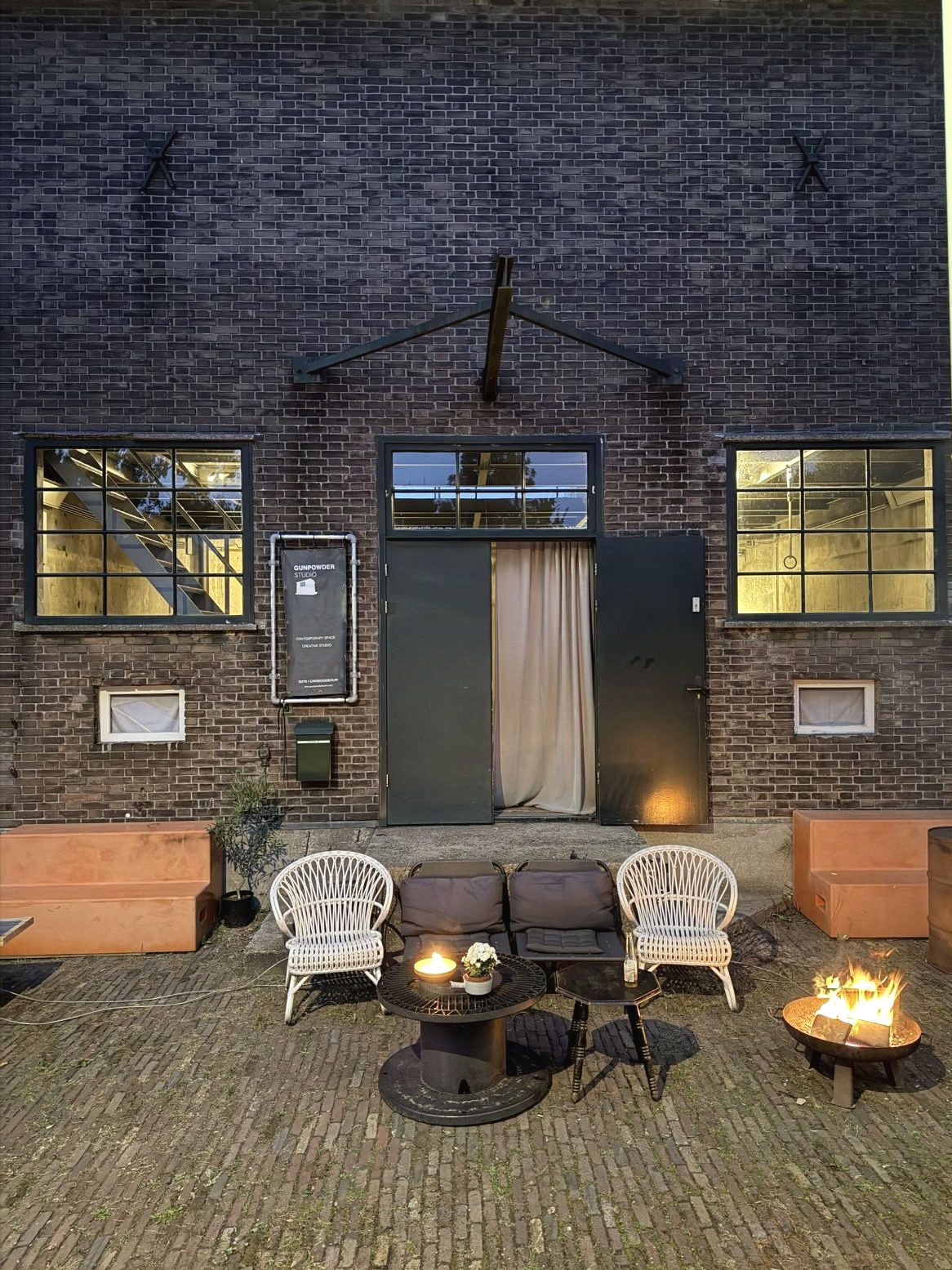 De Gunpowderstudio in de avond, met het vuur buiten